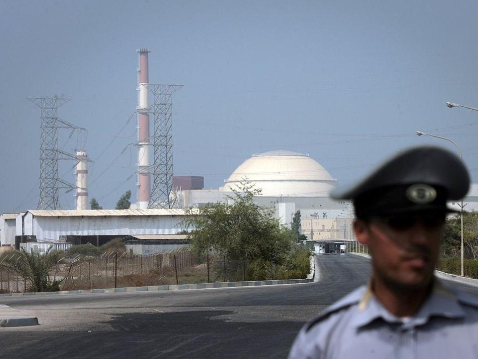 An Iranian security guard standing in front of the Bushehr nuclear power plant on August 20, 2010 in southern Iran