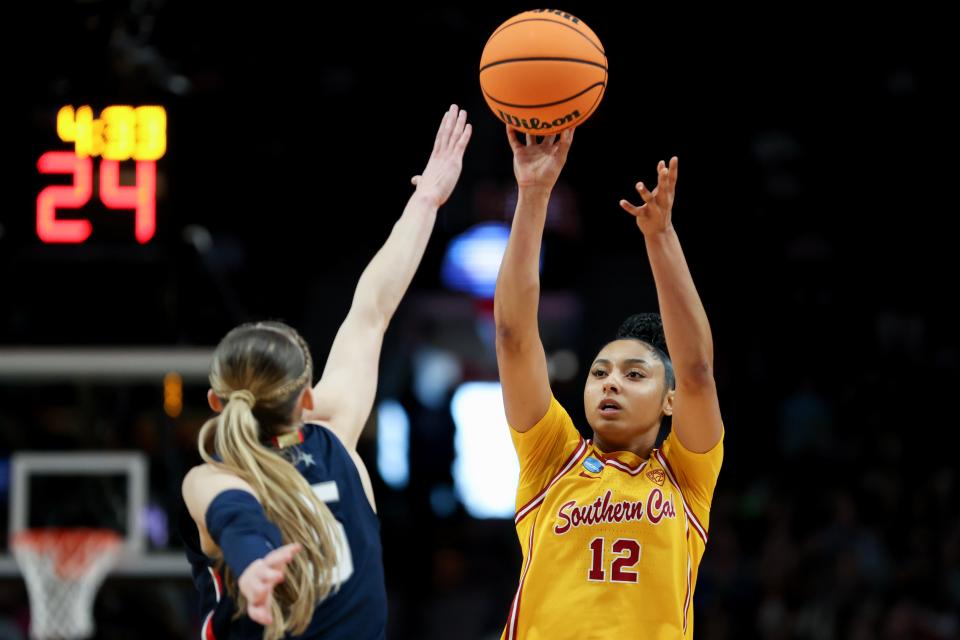 JuJu Watkins #12 of the USC Trojans shoots over Paige Bueckers #5 of the Connecticut Huskies during the first half in the Elite 8 round of the NCAA Women's Basketball Tournament at Moda Center on April 01, 2024 in Portland, Oregon.