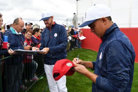 Sep 28, 2016; Chaska, MN, USA; Jimmy Walker (left) and Rickie Fowler (right) sign autographs for fans on the 9th green during the practice round for the Ryder Cup at Hazeltine National Golf Club. Mandatory Credit: Michael Madrid-USA TODAY Sports