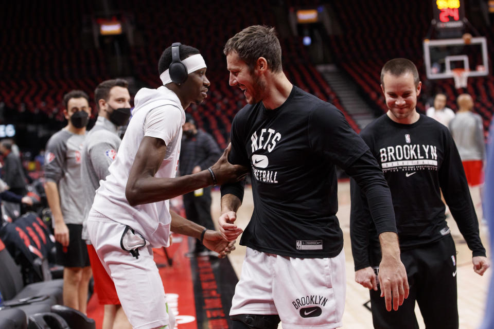 TORONTO, ON - MARCH 01: Chris Boucher #25 of the Toronto Raptors and Goran Dragic #9 of the Brooklyn Nets joke prior to their NBA game at Scotiabank Arena on March 1, 2022 in Toronto, Canada. NOTE TO USER: User expressly acknowledges and agrees that, by downloading and or using this Photograph, user is consenting to the terms and conditions of the Getty Images License Agreement. (Photo by Cole Burston/Getty Images)