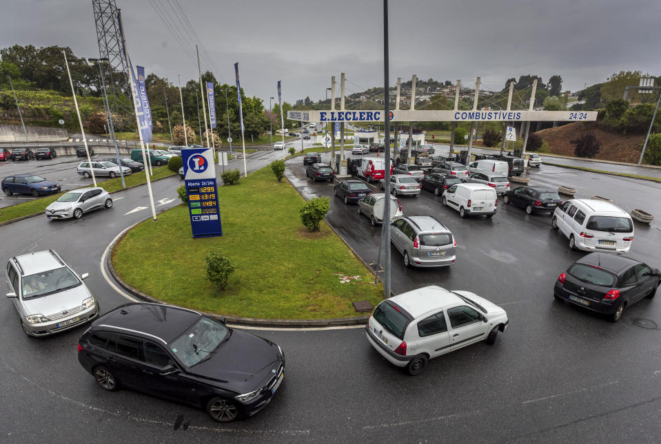 Drivers queue at a gas station in Braga, northern Portugal, Wednesday, April 17, 2019. A strike over pay and working conditions by some 800 truckers who transport hazardous materials prompted a rush to fill tanks, leaving dry hundreds of gas stations across Portugal Wednesday. (AP Photo/Luis Vieira)