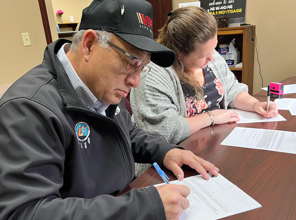 Prairie Band Potawatomi Nation Chairman Joseph Rupnick signs the deed for 128 acres of tribally owned land into federal trust. (Photo provided by the Prairie Band of Potawatomi.)