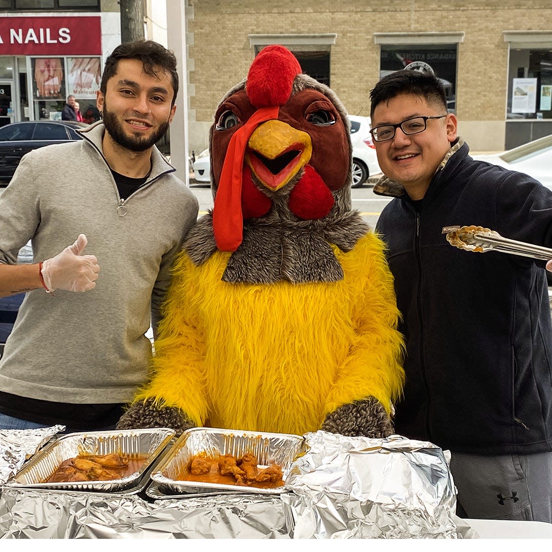 The chicken mascot with some of the Wing Walk restaurant participants from last year's White Plains Wing Walk. The event will be held again April 20 in downtown White Plains.