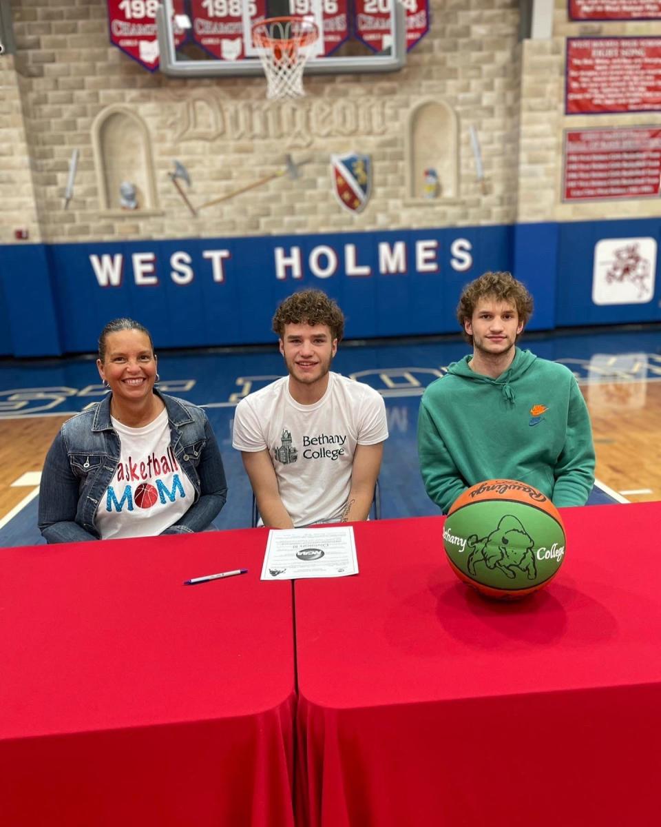 West Holmes' Channer Wells smiles after making his choice to continue his basketball career at Bethany College.