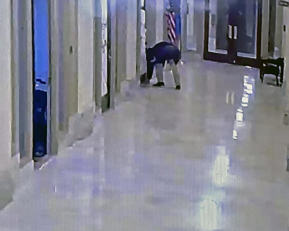 A photo showing an unidentified person slipping a letter from Oklahoma State Department of Education staffer Matt Langston under state Rep. Mark McBride's door. Photo was taken by a House employee who wanted to know who the person slipping the letter under the door was.