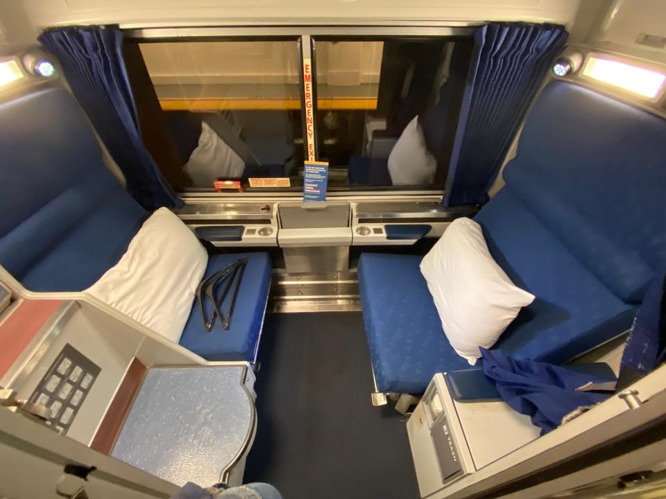 A room aboard the amtrak train with two seats facing each other