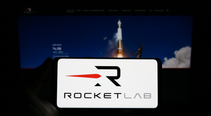 Person holding smartphone with logo of aerospace company Rocket Lab USA Inc. (RKLB) on screen in front of website. Focus on phone display. Unmodified photo.