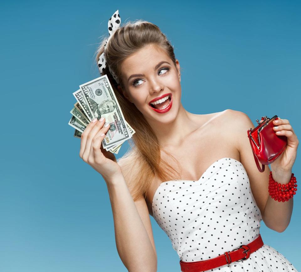 woman holding money arranged like a fan