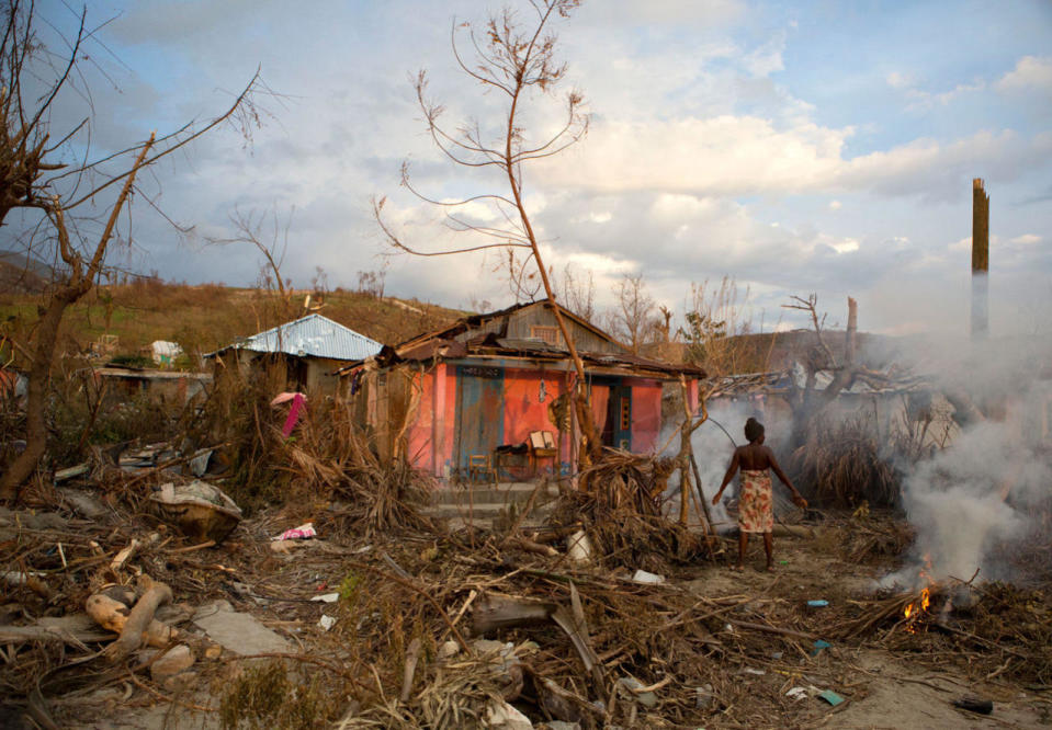 <p>Residents burn the debris of trees shattered by Hurricane Matthew, near Port-a-Piment, Haiti, Monday, Oct. 10, 2016. (AP Photo/Rebecca Blackwell)</p>