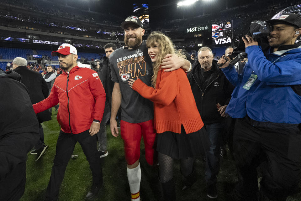 FILE - Kansas City Chiefs tight end Travis Kelce walks with Taylor Swift following the AFC Championship NFL football game between the Baltimore Ravens and the Kansas City Chiefs in Baltimore on Jan. 28, 2024. The Chiefs won 17-10. (AP Photo/Julio Cortez, File)