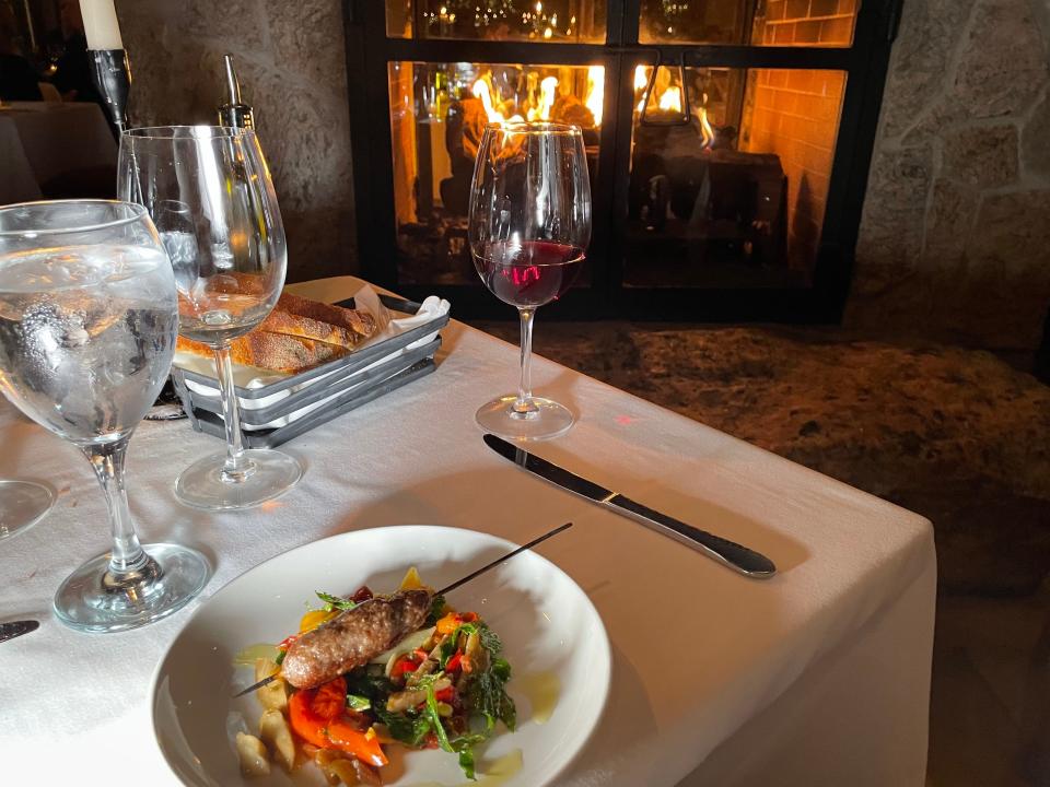 Dinner by the fire at Harvest on Hudson in Hastings-on-Hudson. Photographed Dec. 1, 2023