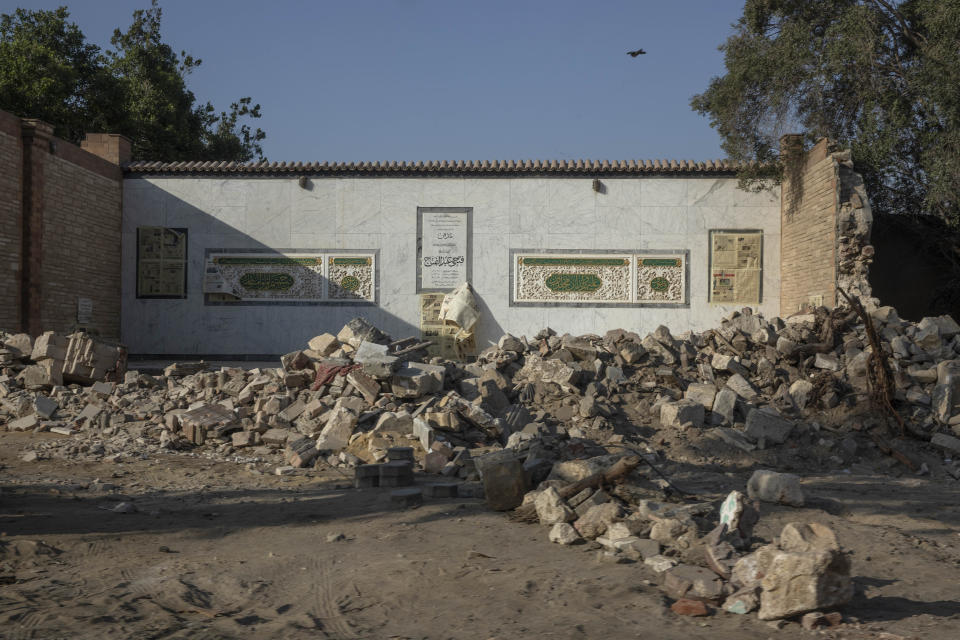 A family grave stands exposed after its walls were knocked down as part of construction of a new highway through the Northern Cemetery, part of the City of the Dead, a UNESCO World Heritage site, in Cairo, Egypt, Tuesday, July 21, 2020. Many of the gravesites partially demolished in the building belong to prominent figures from early 20th Century Egypt, including politicians and writers, and preservationists are raising alarm that the construction harms an area that has been intact for centuries. (AP Photo/Nariman El-Mofty)