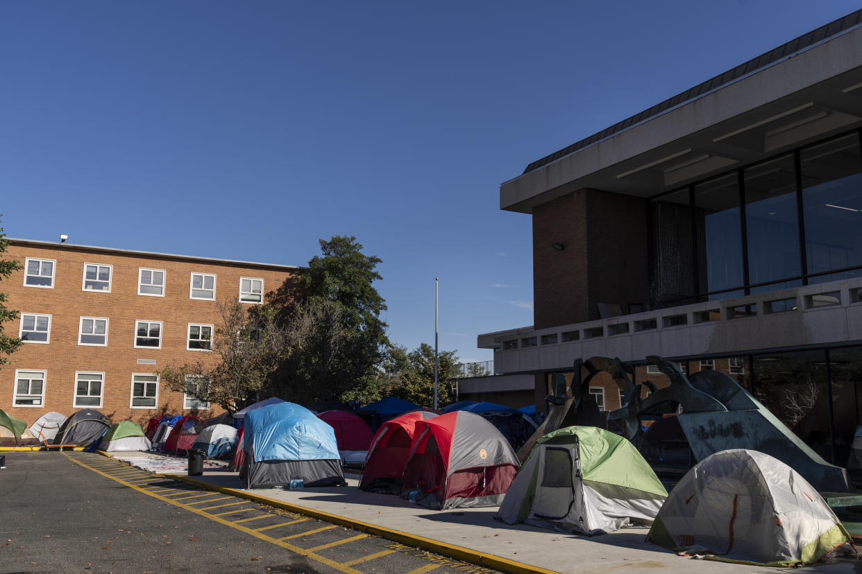 Tents set up near a building on Howard University's campus. 