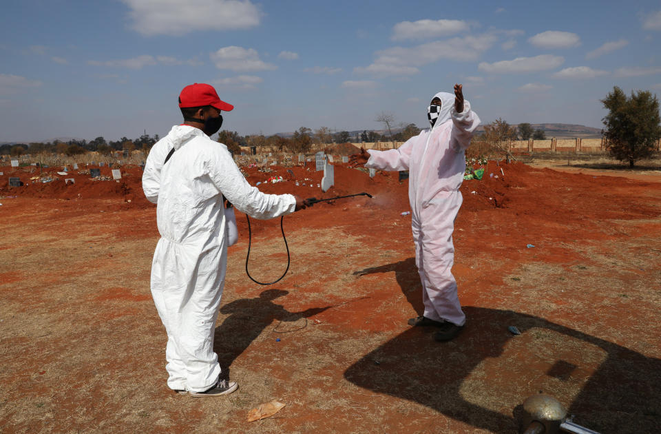 Image: Funeral workers in South Africa (Siphiwe Sibeko / Reuters)