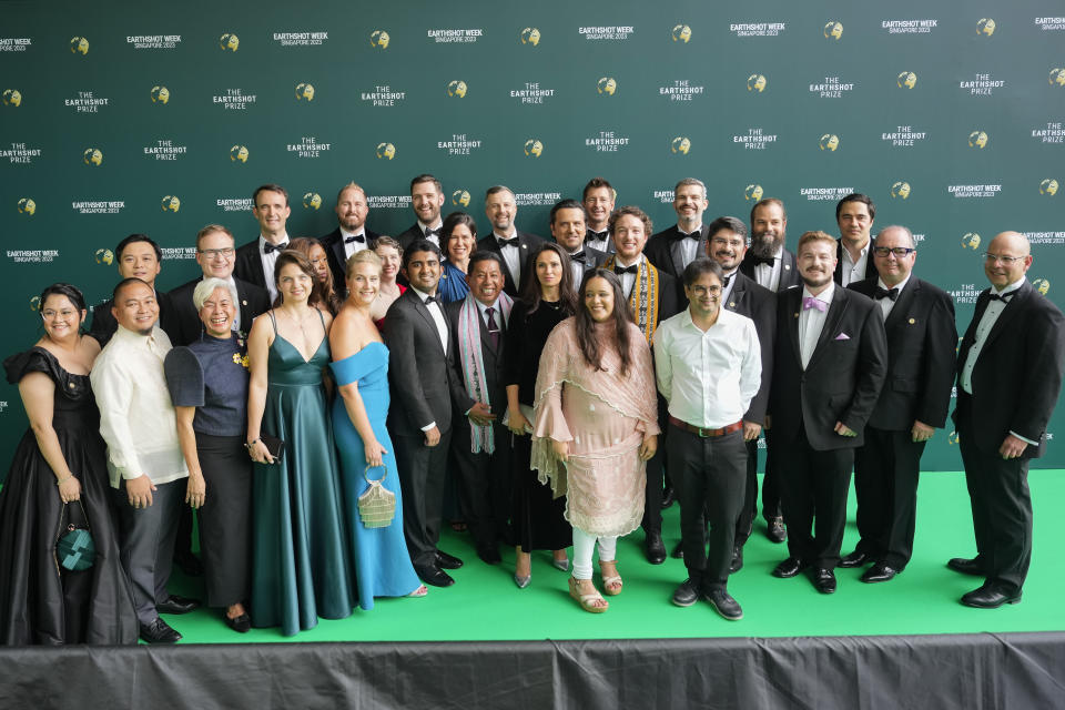 2023 Earthshot prize finalists pose for a picture at green carpet before start of the awards night in Singapore, Tuesday, Nov. 7, 2023. The finalists include a U.S. company that found a way to recycle polycotton fabrics; an Indian company producing solar-powered dryers to help farmers combat food waste; a scheme to plant, grow and digitally track trees in Sierra Leone's capital Freetown and an anti-smog movement in Poland.(AP Photo/Vincent Thian)