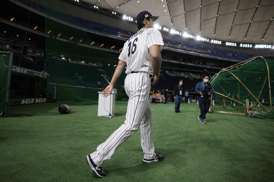 Japan's Shohei Ohtani, walks to participate a group photo session before an official training session prior to the Pool B game at the World Baseball Classic (WBC) at the Tokyo Dome Wednesday, March 8, 2023, in Tokyo. (AP Photo/Eugene Hoshiko)