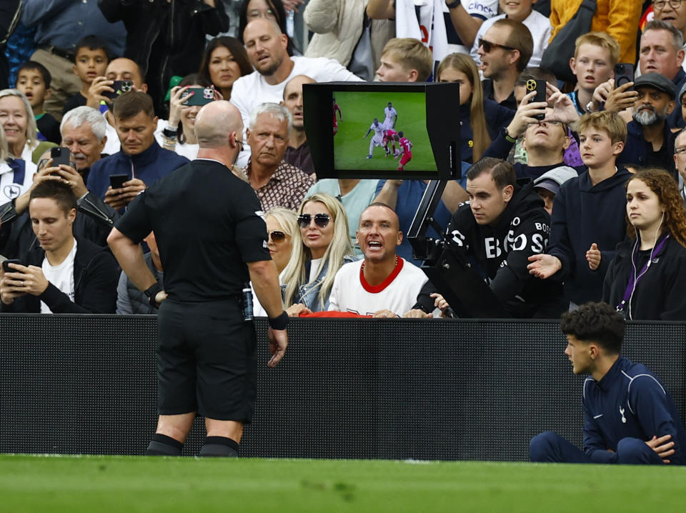 Referee Simon Hooper looks at the VAR monitor before giving Liverpool's Curtis Jones a red card during their English Premier League match against Tottenham Hotspur.