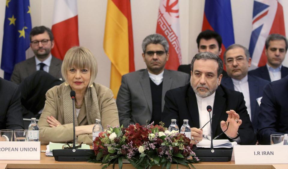 The European Union's political director Helga Schmid and Iran's deputy Foreign Minister Abbas Araghchi, from left, wait for a bilateral meeting as part of the closed-door nuclear talks with Iran in Vienna, Austria, Friday, Dec. 6, 2019. (AP Photo/Ronald Zak)