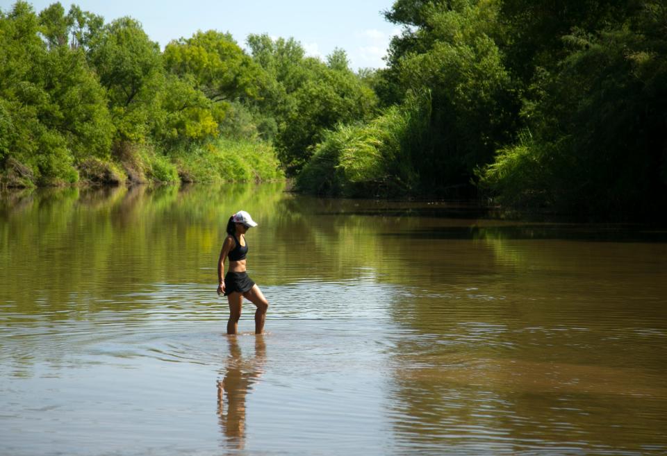 Sray Campanile of Buckeye goes clamming for Asiatic clams in the Verde River at the Needle Rock Recreation Site outside of Rio Verde on July 28, 2021.