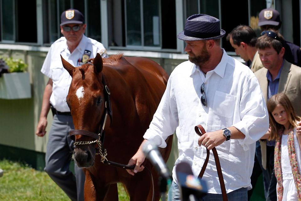 Trainer Doug O'Neil walks with I'll Have Another during a press conference outside of barn two on June 8, 2012 in Elmont, New York. It was announced earlier in the day that I'll Have Another has been scratched from the 2012 Belmont Stakes, ending his bid for a Triple Crown. (Photo by Rob Carr/Getty Images)