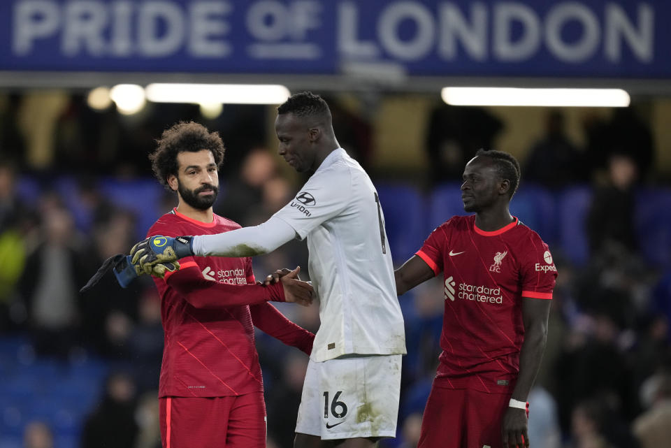 Chelsea's goalkeeper Edouard Mendy and Liverpool's Mohamed Salah embrace after the English Premier League soccer match between Chelsea and Liverpool at Stamford Bridge in London, Sunday, Jan. 2, 2022. The match ended in a 2-2 draw. (AP Photo/Matt Dunham)