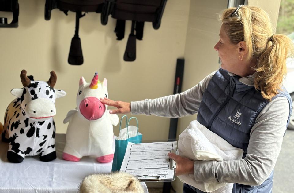 Stephanie Lamb, of Wells, Maine, showcases some of the toys she includes among the baby gear she rents out to local clients through her business, BabyQuip.