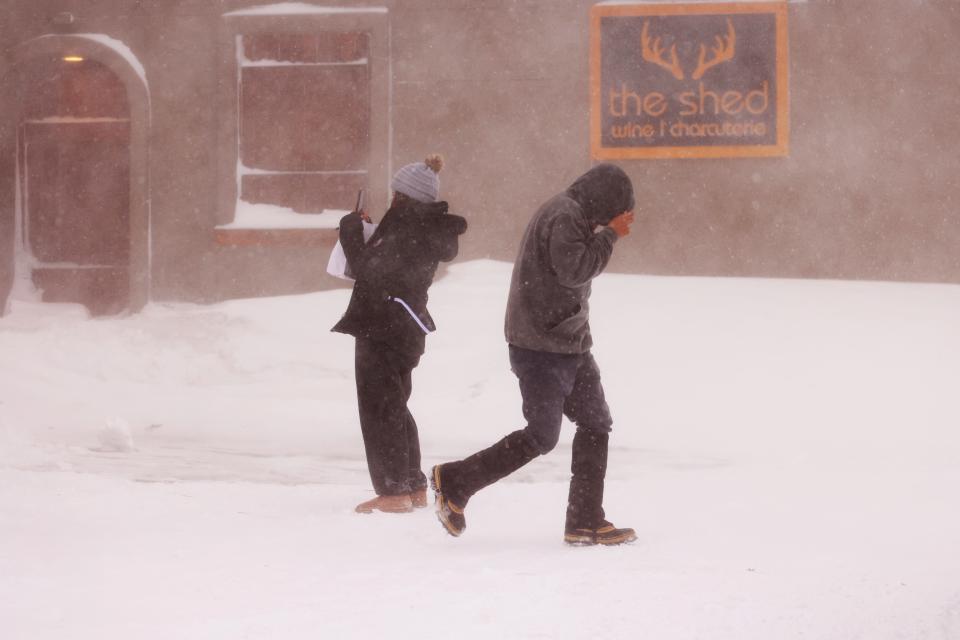 People take photos and cover their faces as a blizzard hits Mammoth Lakes, California, on March 2, 2024. The National Weather Service has issued a blizzard warning for California's entire Sierra Nevada through early March 3, 2024. Forecaster report the storm could bring three to five inches (8 to 13cms) of snow per hour. (Photo by DAVID SWANSON / AFP) (Photo by DAVID SWANSON/AFP via Getty Images) ORG XMIT: 776114505 ORIG FILE ID: 2046487719