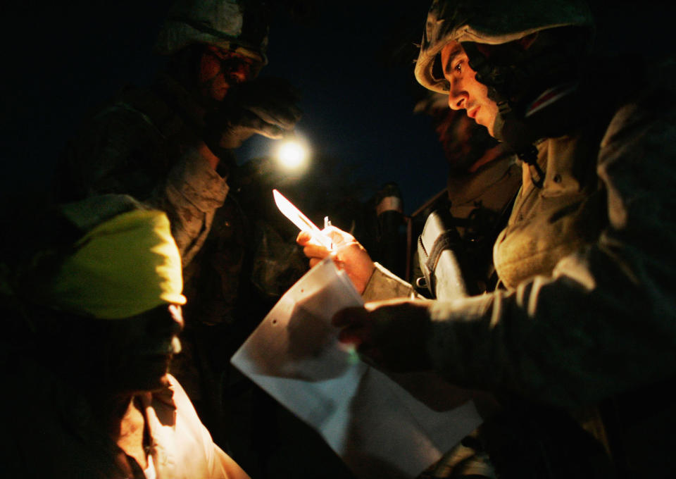 <p>Marines of the Third Battalion, Fourth Marines, process a detained man June 24, 2005 near Fallujah, Iraq. Marines in the 3/4 launched the midnight raid in the rural suburbs of Fallujah and detained 19 men, the Marines said. (Photo by Chris Hondros/Getty Images) </p>