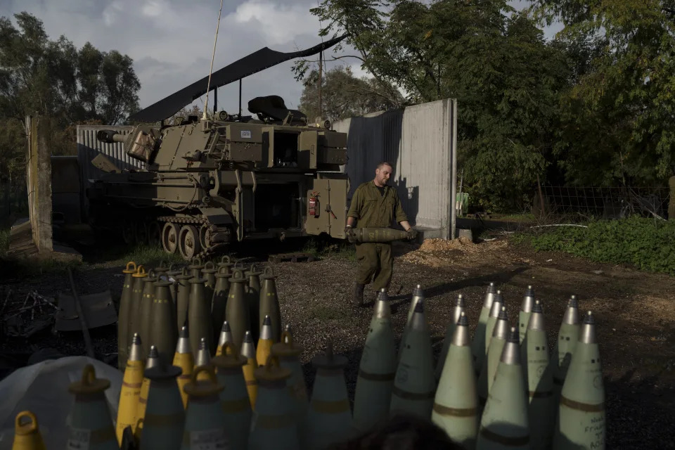 An Israeli soldier carries a howitzer shell near the border with Lebanon, in northern Israel, Thursday, Jan. 11, 2024. The prospect of a full-scale war between Israel and Lebanon’s Hezbollah militia terrifies people on both sides of the border, but some see it as an inevitable fallout from Israel’s ongoing war against Hamas in Gaza. (AP Photo/Leo Correa)