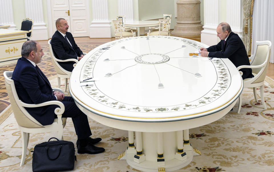 Russian President Vladimir Putin, right, attends a talks with Azerbaijan's President Ilham Aliyev, second left, and Armenian Prime Minister Nikol Pashinyan, left, in the Kremlin in Moscow, Russia, Monday, Jan. 11, 2021. Putin hosted the leaders of Armenia and Azerbaijan for talks after six weeks of fierce fighting over Nagorno-Karabakh that ended with a Russia-brokered peace deal in November. (Mikhail Klimentyev, Sputnik, Kremlin Pool Photo via AP)
