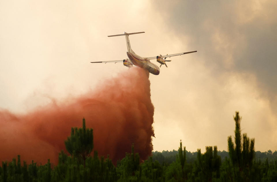 A firefighting plane drops flame retardant to extinguish a fire in Belin-Beliet, as wildfires continue to spread in the Gironde region of southwestern France, August 10, 2022. REUTERS/Stephane Mahe