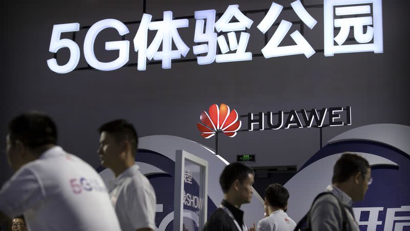 Visitors look at a display for 5G wireless technology from Chinese technology firm Huawei at the PT Expo in Beijing on Wednesday, Sept. 26, 2018.