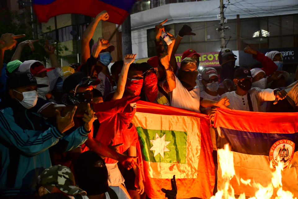 Anti-government protesters gather near Romelio Martinez stadium where a Copa Libertadores soccer match between Colombia's América de Cali and Brazil's Atlético Mineiro is being played, in Barranquilla, Colombia, Thursday, May 13, 2021. Protesters are demanding that soccer matches in Colombia should be cancelled during their ongoing protests against the government of President Ivan Duque. (AP Photo)