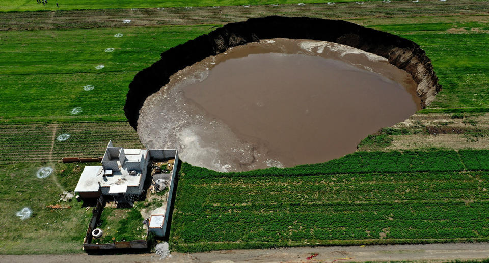 Aerial view of a sinkhole that was found by farmers in a field of crops in Santa Maria Zacatepec, Mexico.