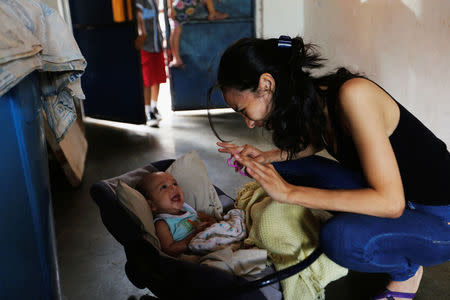 Yennifer Padron plays with her baby in her house at Petare slum in Caracas, Venezuela, August 21, 2017. REUTERS/Andres Martinez Casares/Files