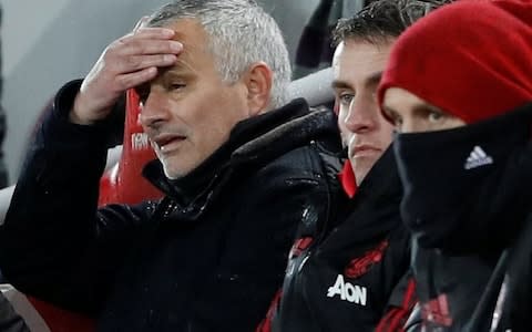Jose Mourinho touches his forehead on bench - Credit: Action Images