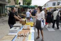 Valerie Laupies (right), far right National Front party candidate in Bouches-du-Rhone, campaigns at a market in Saint-Martin-de-Crau, southern France. Sunday's vote will be a litmus test for Marine Le Pen's far-right anti-immigrant National Front party, after Le Pen won 18 percent of votes in the first round of the presidential election