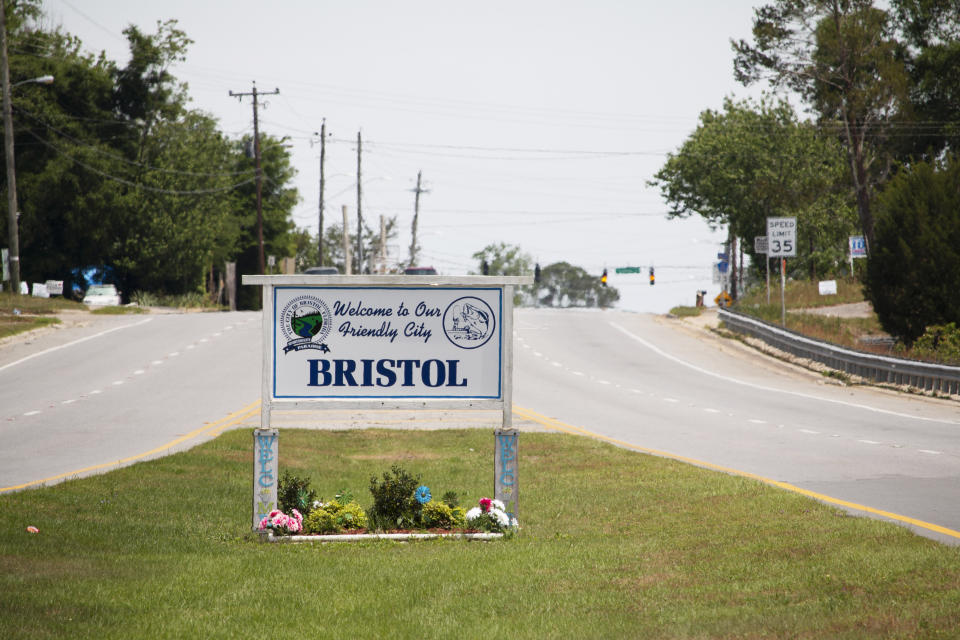 In this April 11, 2020 photo, the sign entering the city of Bristol in the Florida Panhandle advertises the community as a friendly city. But these days, townsfolk haven't been as welcoming to outsiders, as Liberty County attempts to fend off further spread of the coronavirus. (AP Photo/Bobby Caina Calvan)