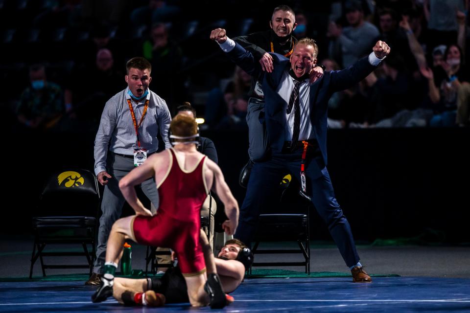 John Oostendorp, right, celebrates Brock Henderson's national title in 2021.