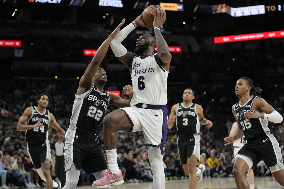 Los Angeles Lakers forward LeBron James (6) drives to the basket against San Antonio Spurs guard Malaki Branham (22) during the second half of an NBA basketball game in San Antonio, Saturday, Nov. 26, 2022. (AP Photo/Eric Gay)