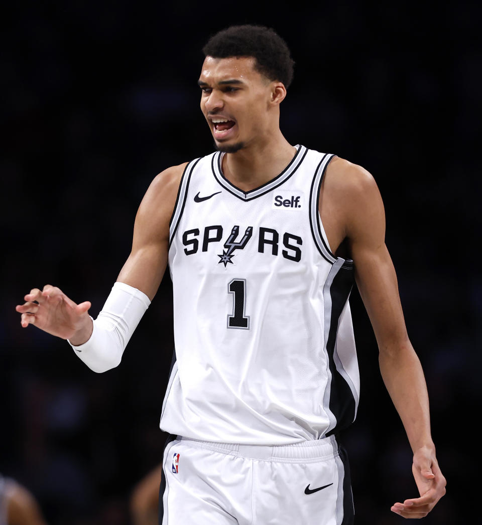 San Antonio Spurs center Victor Wembanyama (1) reacts during the first half of an NBA basketball game against the Brooklyn Nets, Saturday, Feb. 10, 2024, in New York. (AP Photo/Noah K. Murray)