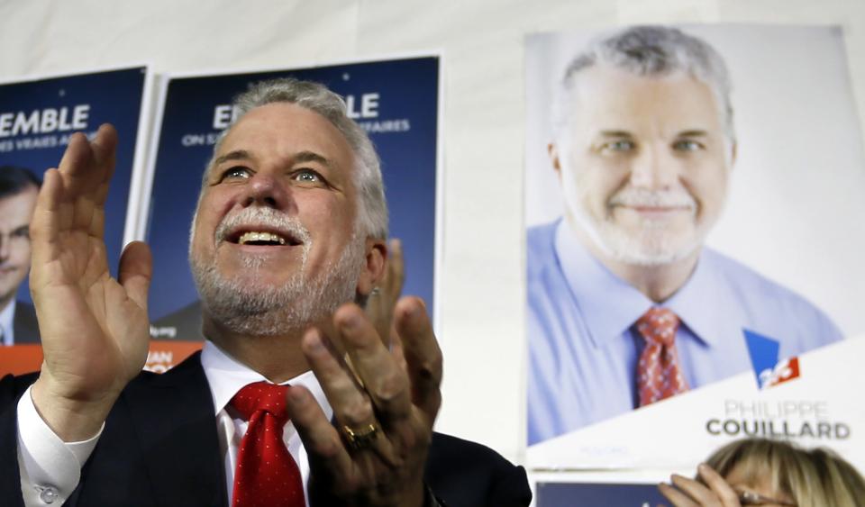 Liberal leader Philippe Couillard gestures as he speaks to supporters at a campaign stop in Laval