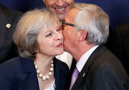 European Commission President Jean-Claude Juncker kisses Britain's Prime Minister Theresa May as they pose for a family photo during a European Union leaders summit in Brussels, Belgium, October 20, 2016. REUTERS/Francois Lenoir