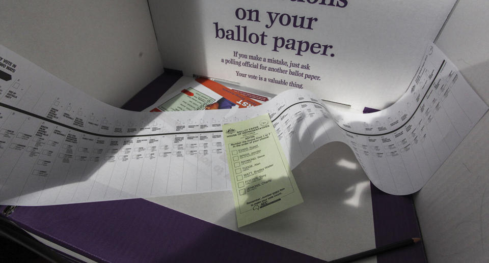 Two ballot papers lie on a polling booth during the federal election.