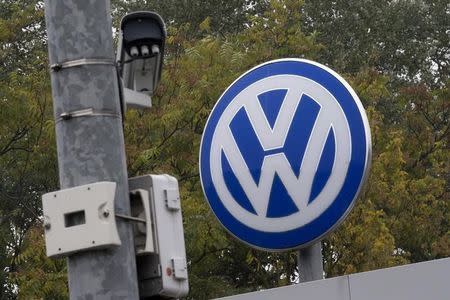 A Volkswagen logo stands next to a CCTV security camera in Wolfsburg, Germany October 7, 2015. REUTERS/Axel Schmidt