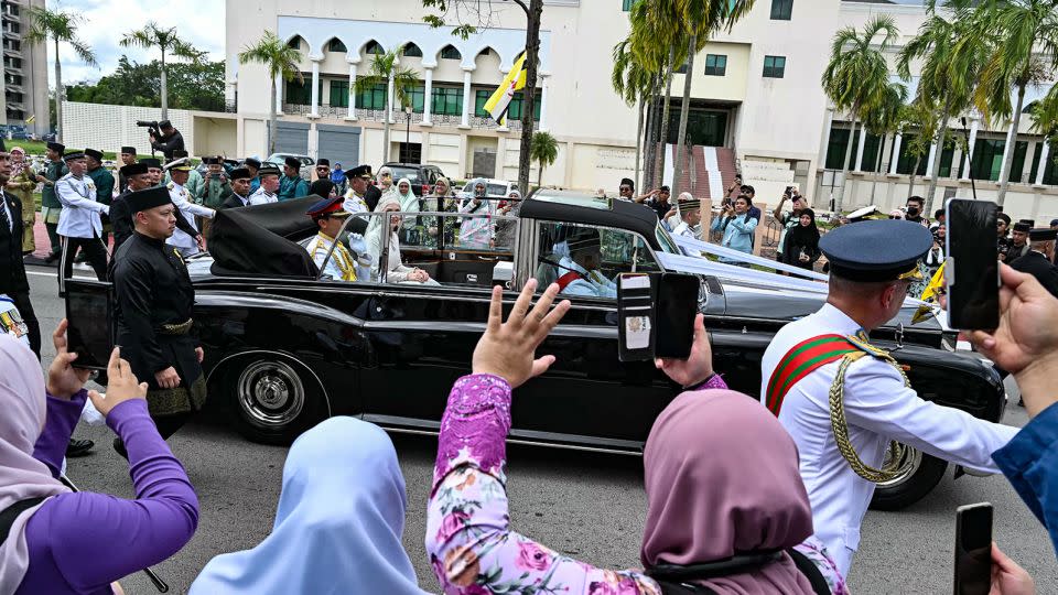 Crowds gather in the streets of Bandar Seri Begawan to cheer the royal newlyweds. - Mohd Rasfan/AFP/Getty Images