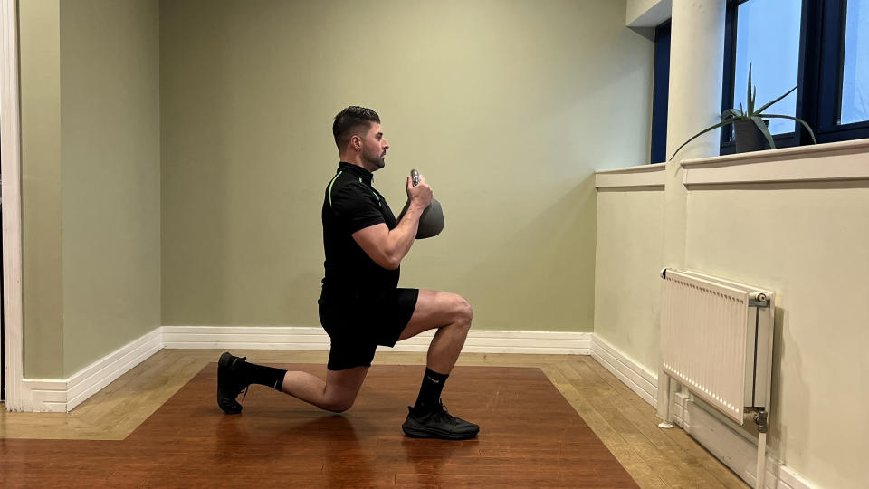 Sam Quinn, strength coach at Nuffield Health, demonstrates a reverse lunge