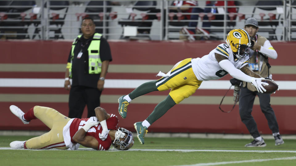 Green Bay Packers wide receiver Amari Rodgers, right, dives past San Francisco 49ers safety Tayler Hawkins to score a touchdown during the second half of an NFL preseason football game against the San Francisco 49ers in Santa Clara, Calif., Friday, Aug. 12, 2022. (AP Photo/Jed Jacobsohn)
