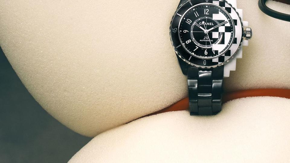 black chanel watch wrapped around a large piece of foam