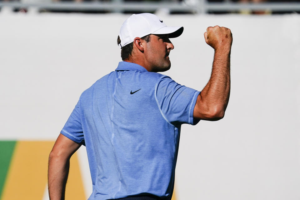 Scottie Scheffler pumps his fist after making par on the 16th hole of the final round of the Phoenix Open golf tournament, Sunday, Feb. 12, 2023, in Scottsdale, Ariz. (AP Photo/Darryl Webb)